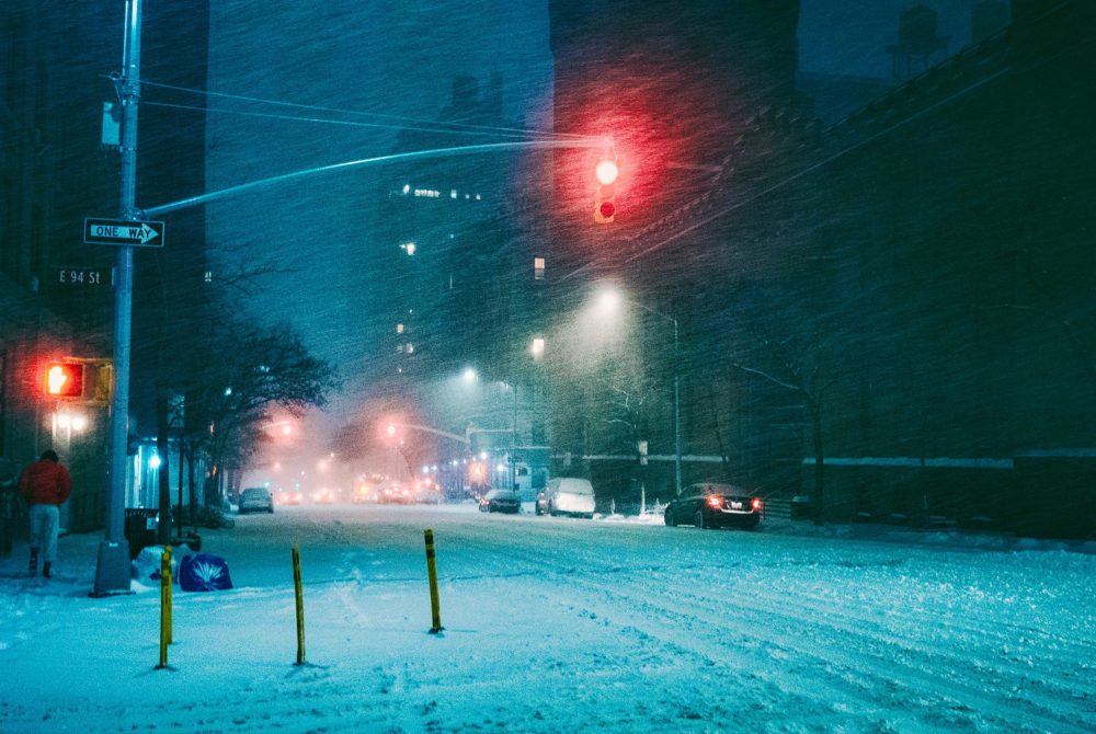 snowy city street traffic lights