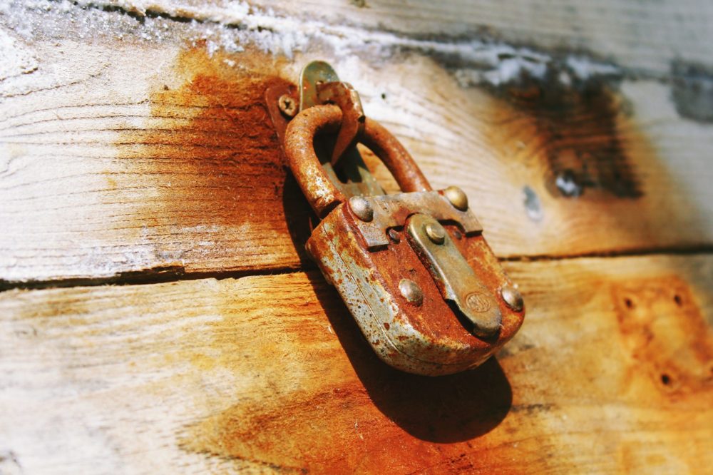 rusty padlock on wood signifying the Latch Key Life