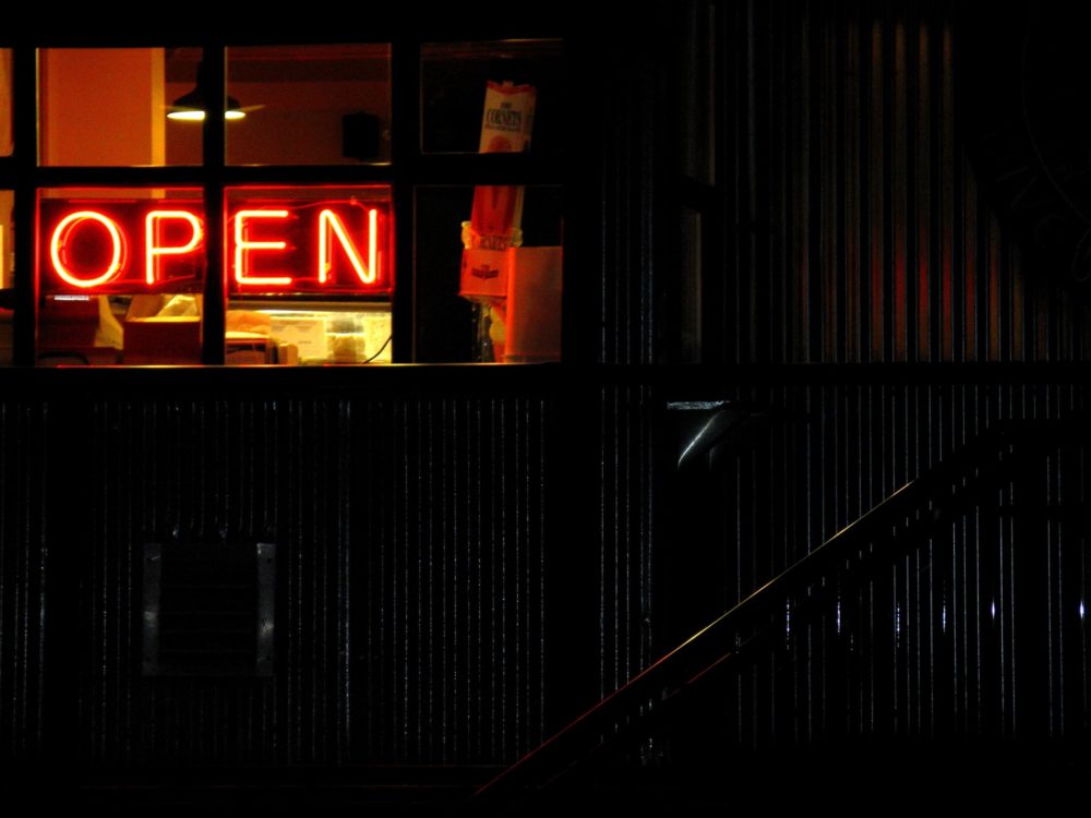 neon open sign in a dive bar window